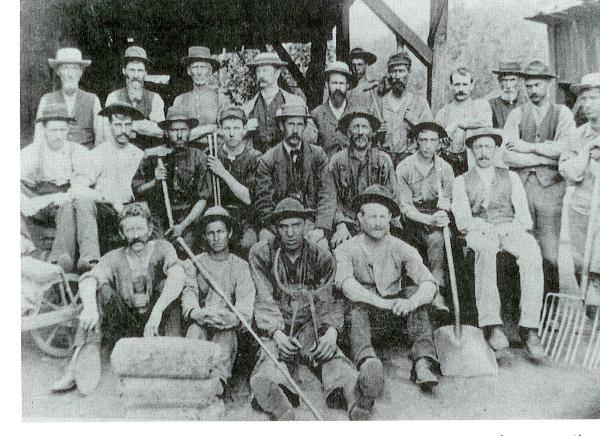 Group photograph of workers with tools.