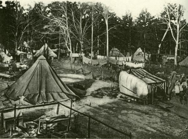 Image of tents, makeshift kitchens, and miners.