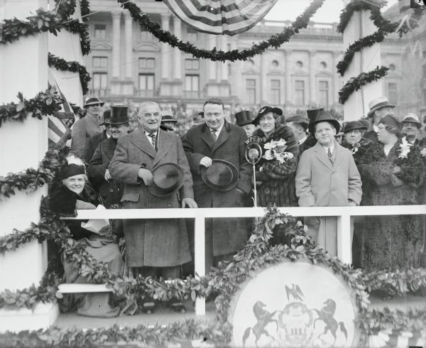 Standing on the reviewing stand, left to right, are Senator Joseph Guffey, Governor George Earle, Mrs. G.H. Earle and Harry Earle son of the Governor.