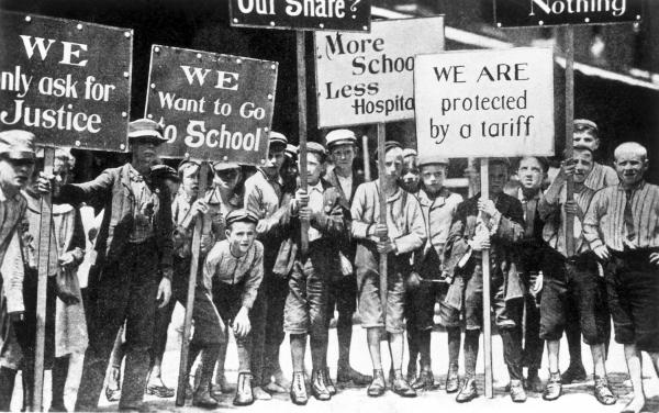 A group of children holding placards.