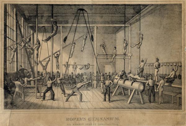 Advertisement showing the interior of the well-attended gymnasium, operated by James Roper on the 800 block of Market Street, in which several men exercise in front of a crowd of spectators. In the right, three men perform balance moves on a balance beam next to a wall adorned with a rack from which boxing gloves and squash rackets hang. Beside the beam, two men wearing boxing gloves converse near the pummel horse that two men utilize. In the front center and left of the room, two pairs of men, one pair wearing face guards, fence; two men pull weights attached to the ceiling; and another tests his strength on the parallel bars near men climbing poles. To the rear, other exercisers climb vertical and inclined ropes, hang and climb from exercise ladders, straddle and perform pull-ups on horizontal poles, and dangle upside down from a trapeze. Around the room, spectators including several men and a few women in winter clothing, stand and sit to watch the gym attendees. Roper established the gymnasium circa 1831 which relocated to the 800 block of Walnut Street