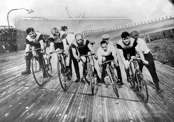 Image of men riding bicycles on a track.