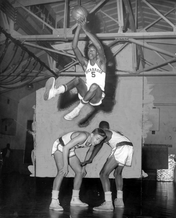 Overbrook High School's Wilt Chamberlain makes shot in game against Southern High School.