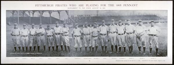 Team photograph of members standing on a ball field.
