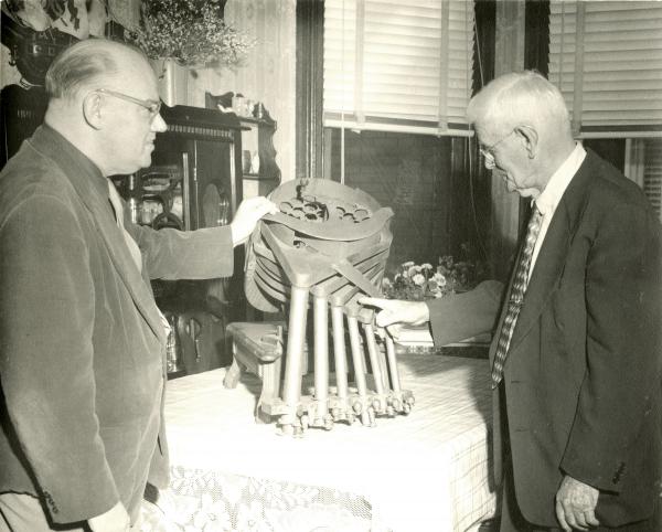 Billy Bowman and Warren J. Harder with a Drawbaugh coin separator. 