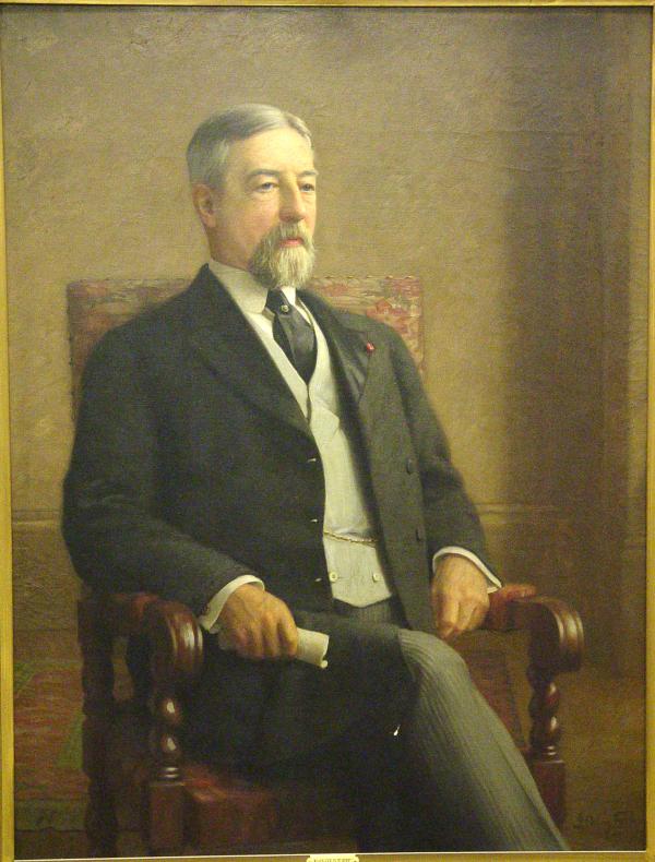 Oil on canvas of a bearded man, seated and wearing a suit.