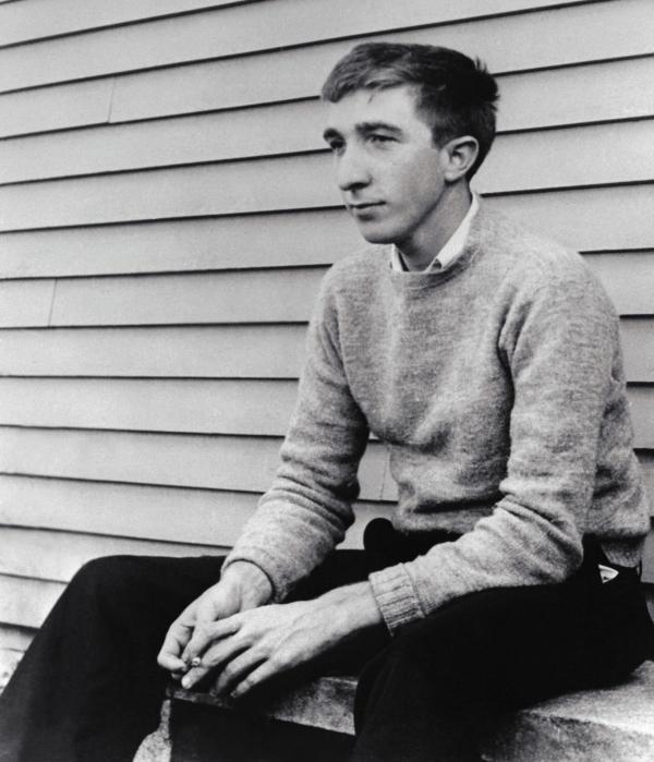John Updike seated