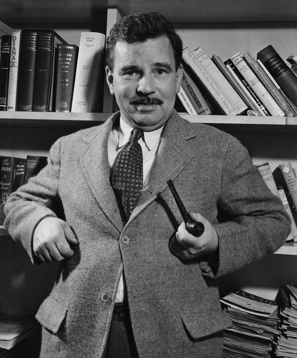 Malcolm Cowley Standing with Pipe