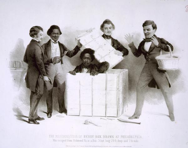 In the office of the Pennsylvania Anti-Slavery Society, the young Brown emerges from a crate as several figures, including Frederick Douglass (holding a claw hammer at left) look on.