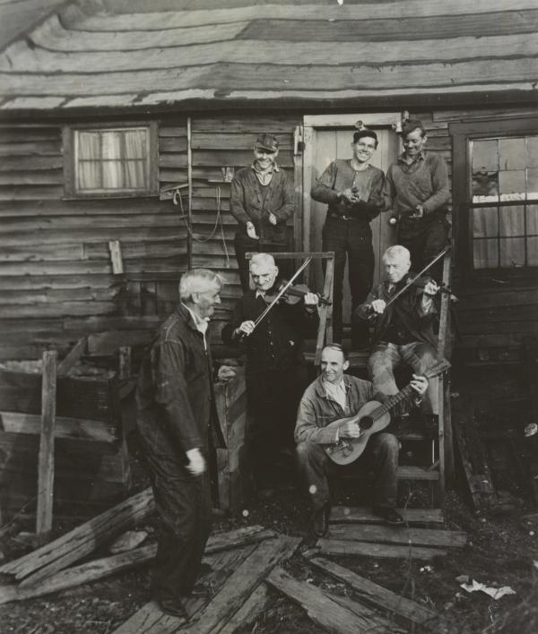 George Korson recording staged hoedown in Pennsylvania, with anthracite miners playing fiddle and guitar. 