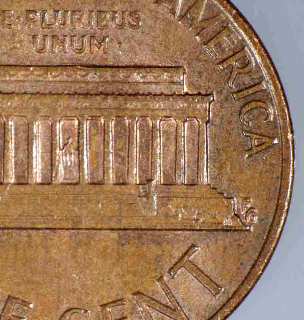 Rear side of penny with Gasparro's initials 
