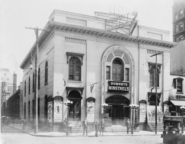 Exterior of "11th St. Opera House," a Philadelphia theater advertising Dumont's Minstrels, burlesque, and Buffalo Bill's Ranche 101.