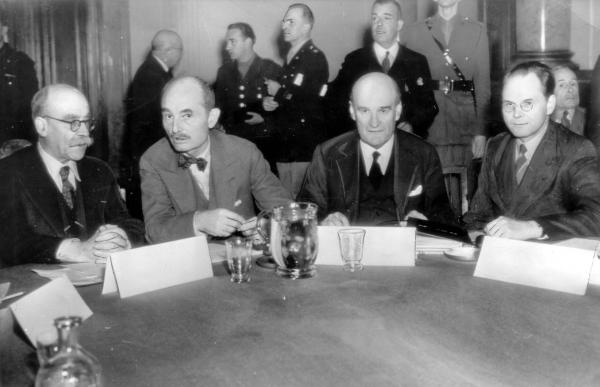 Four men seated at a table.