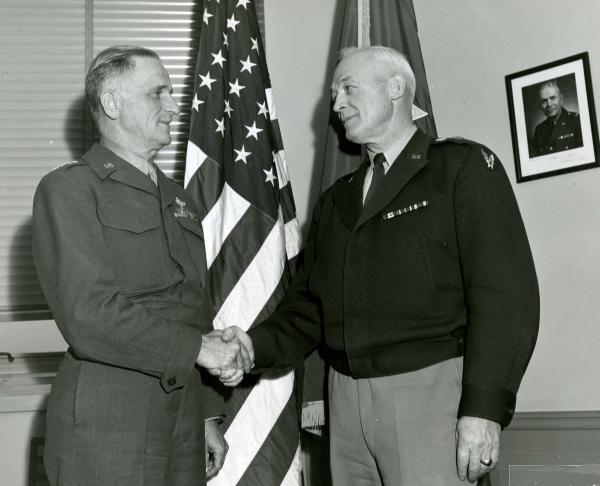 Photograph of General Henry Arnold and General Carl Spaatz  standing and shakings hands.