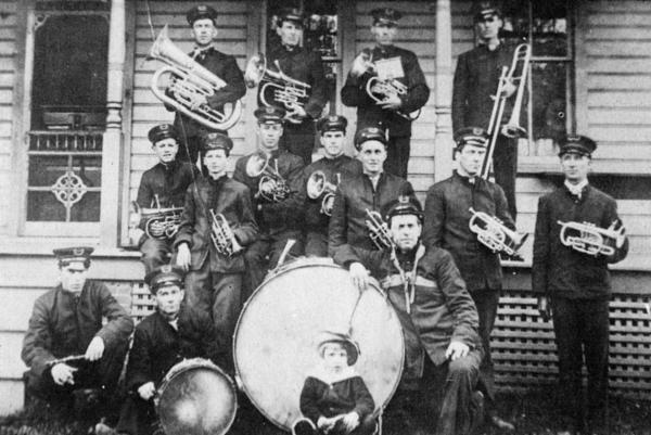 Group photograph of the band with instruments.