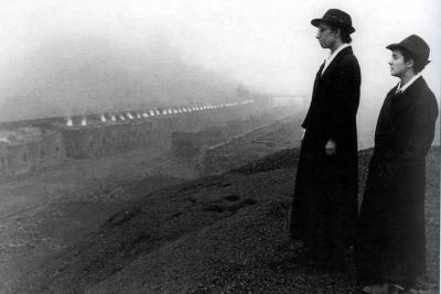 Black and white photograph of two Missionary Trinitarian Sisters of the Most Blessed Trinity and row of working Coke Ovens.