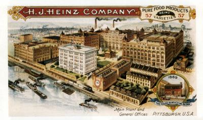 Color image of the Heinz complex bordering the railroad tracks and the river, which is full of steam ships.