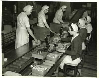 Production; wrapping department, Kiss; female employees; assembly line, women verifying weight of 2 pound boxes, 1936-1937