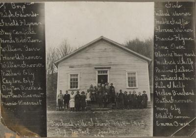 Exterior, Birchardville One Room School with students posing in front.