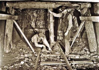 Workers install beams in a coal mine  
