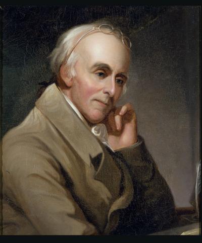 Oil on canvas of Benjamin Rush as he sits at his desk, elbow resting on the desk and his head rests against his hand. His glasses are propped on the top of his balding head.