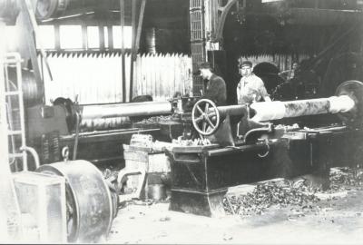 Interior of Axle shop and workers.
