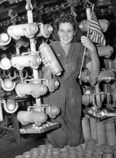 Florence McMillan, a worker at the Budd Mfg. Co., surrounded by 20-pound fragmentation bombs manufactured for the U.S. Army.