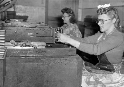 Image of two women shooting machine guns.