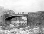 Photo shows the bridge before sidewalks were added to its flanks.