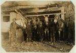 Boys with their mules, standing at the entrance of the mine.