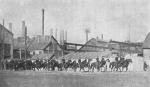 Cossacks on horseback leaving a steel mill.