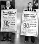 Photograph of two picketers with signs.