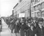 Loyalty Parade; men and women workers are marching; holding signs that read: Down With Communistic Idiotic Laws, CIO Can't Make a Monkey Out of Us, and Hershey Fills Our Breadbaskets, not the CIO  