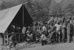 Photograph of men gathering at the mess tent for dinner.