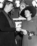 Pearl Buck receiving a check from First Lady Eleanor Roosevelt for the China Relief Legion, December 16, 1940.