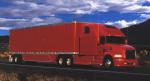 Color photograph of a sleek, red, tractor trailer truck.
