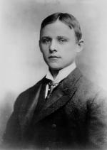Black and white portrait of a young man in a suit.