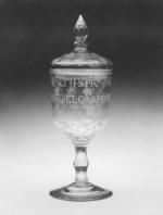 Pokal or Covered colorless leaded glass goblet with cut stem. Engraved, <i>Health and Prosperity to Emanuel Carpenter My Most Generous Promoter</i> 