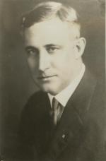 Head and shoulders image of a man in a suit and tie.