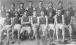 Carlisle Indian School Track Team of 1909, with Coach Warner, a trophy and a pennant that reads Carlisle. 