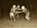 Willie Thrower straight arming a defender in a football game in progress.