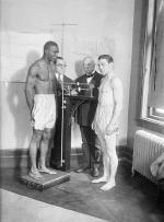  Left to right: Tiger Flowers, 157 1/2 pounds  (on scales), Bert Stand, Secretary of Boxing Commission; Com. Muldoon; and  Harry Greb 159 pounds;. The bout took place at Madison Square Garden.