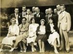 A group of people pose for a photograph. In the front row five, well-dressed women are seated in chairs. In the second row five men wearing suits are standing. The man in the middle of that row is James Maurer.In the third and last row, five men wearing suits are standing.  