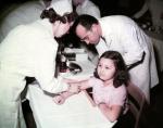 Dr. Jonas E. Salk and a nurse administer a polio vaccine to Pauline Antloger.