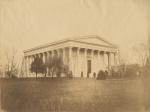 View looking southwest showing the hall constructed 1833-1847 in the Greek Revival Style after the designs of Philadelphia architect Thomas Ustick Walter. Also shows a partial view of a neighboring building left of the hall and several trees in the foreground.   