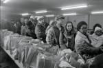 People line up to get bags of food at a food bank for unemployed steelworkers in Braddock, Pennsylvania, January 25, 1983. 