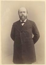 Henry George standing with hands behind his back.