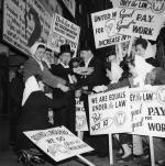 Equal Rights Movement Demonstration During the 1946 Strike. Two Men are Dressed in Tuxedos and Smoking Cigars, and Women are Holding Picket Signs. 