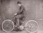 George M. Holley riding on his Motor Bicycle