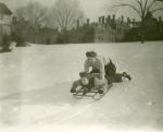 Students at Westtown School, on a snow covered hill, riding a Flexible Flyer  